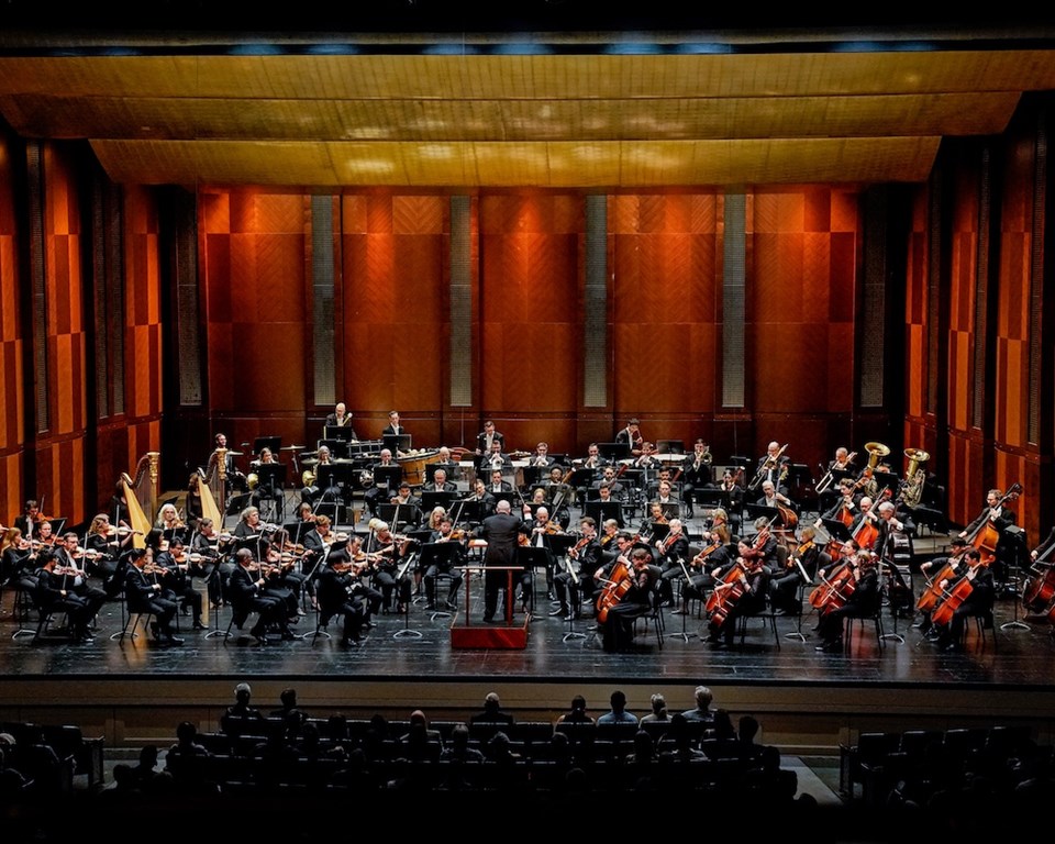 Fort Worth Symphony Orchestra taking bows with audience standing in cheer