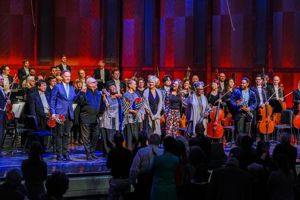orchestra, conductor, composer, librettist, and dancers on stage taking bow
