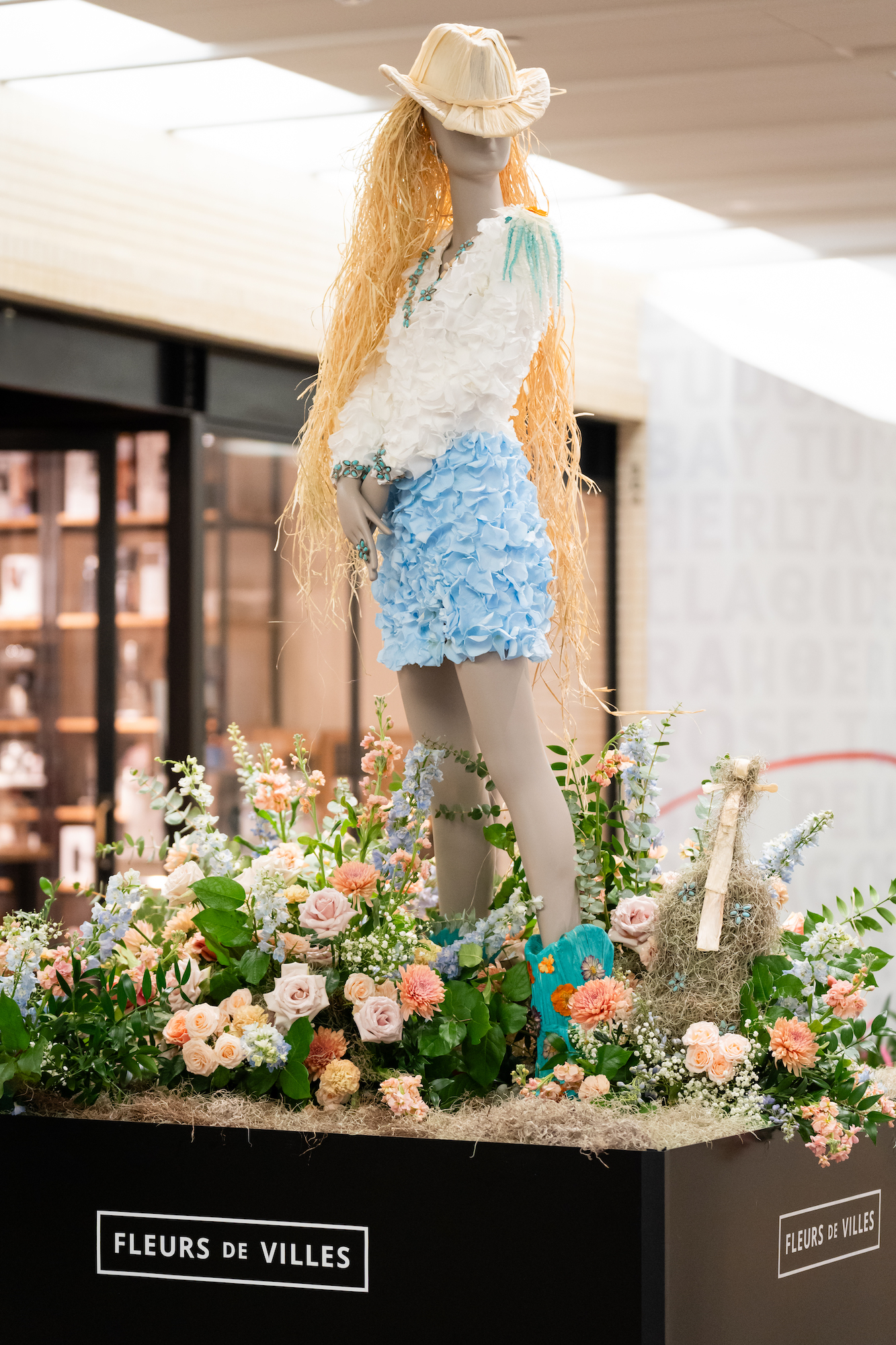 floral mannequin of cowgirl with violin
