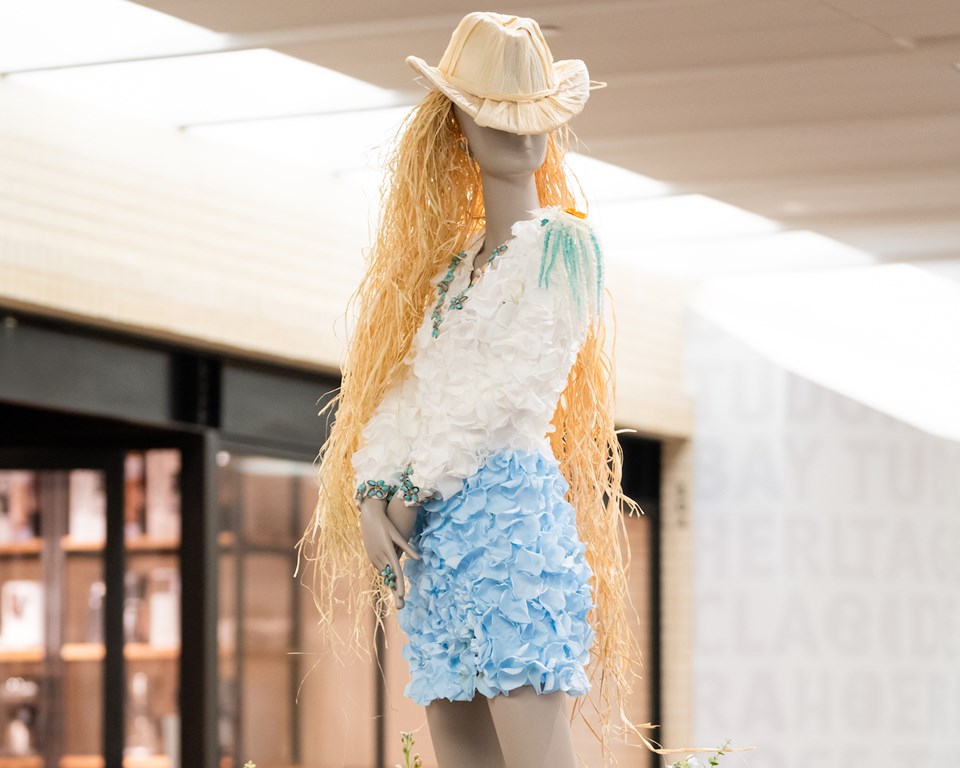 floral mannequin of cowgirl with violin