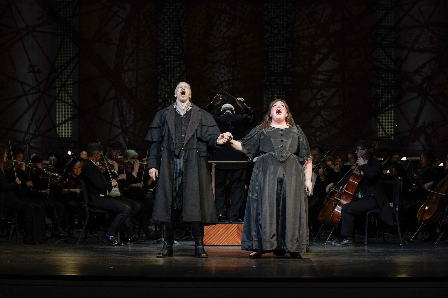 Male and female opera singer singing and holding hands